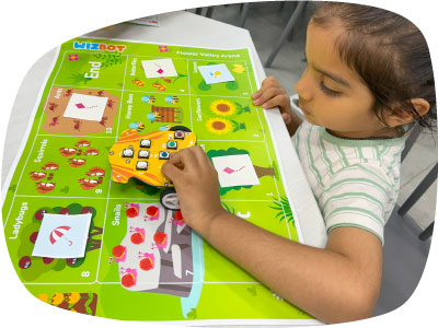 Kid with screen-free robot toy learning logical reasoning