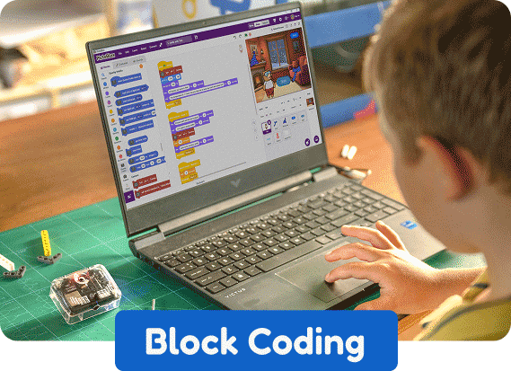 Boy using block coding to program Quarky Intellio projects